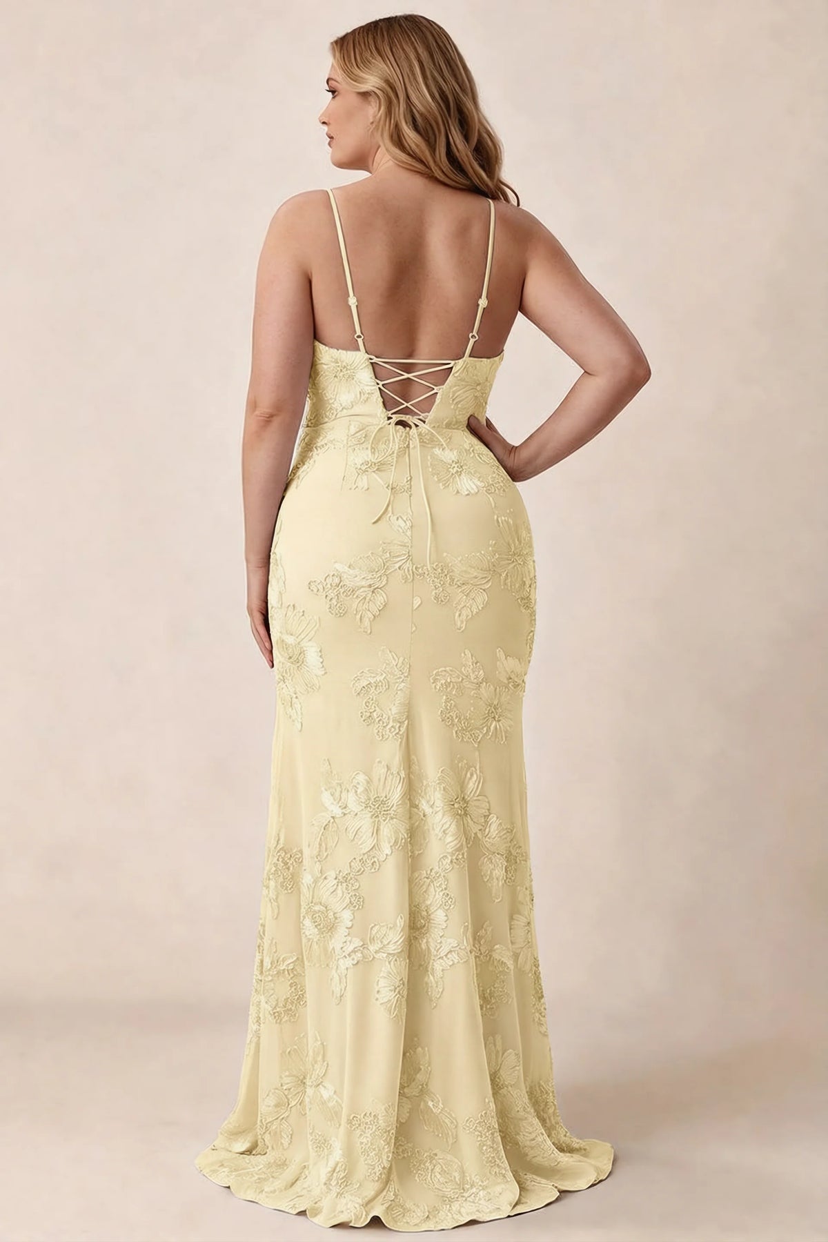 Rear studio view of Brianna lemon floral dress showing the fitted hips and long hem
