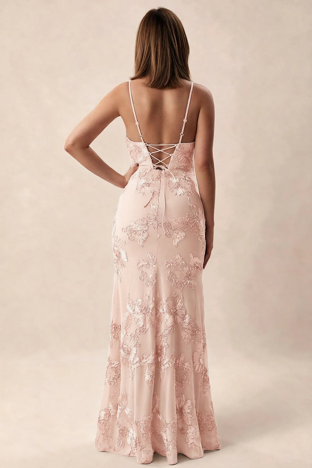 Rear studio view of Brianna light pink dress showing adjustable shoulder straps and crossed back lacing