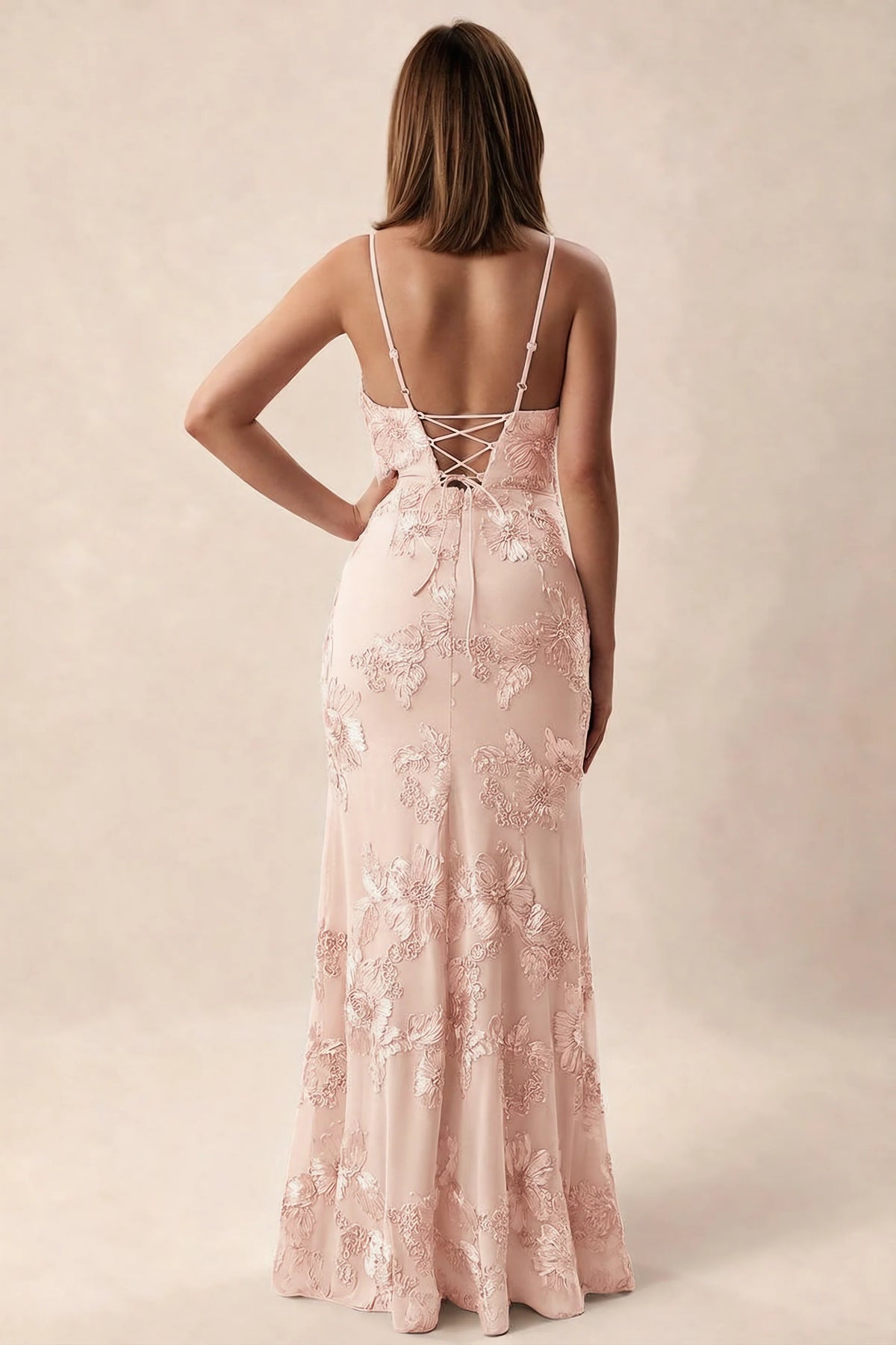 Rear studio view of Brianna light pink dress showing adjustable shoulder straps and crossed back lacing