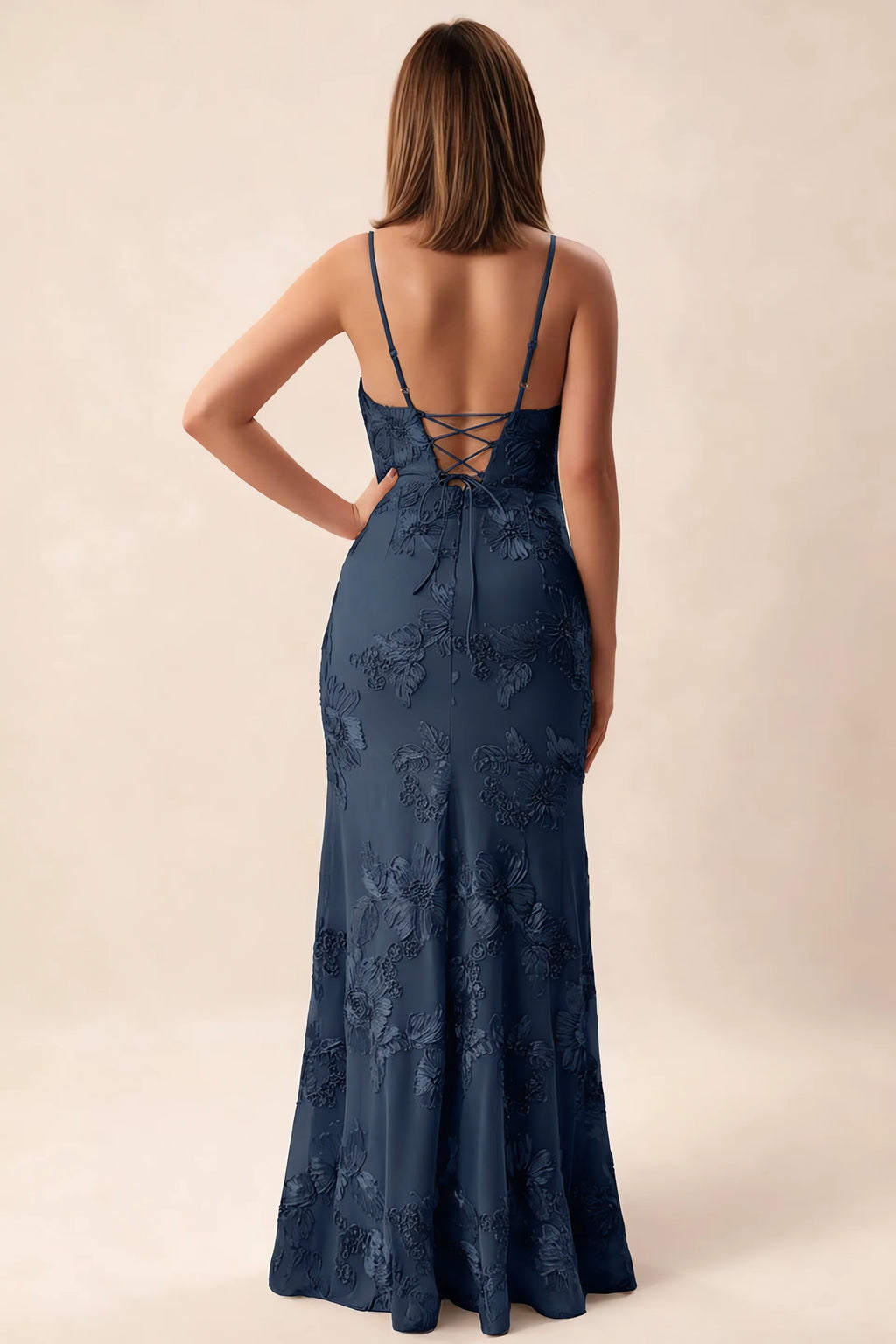 Rear studio view of Brianna navy dress showing adjustable shoulder straps and crossed back lacing