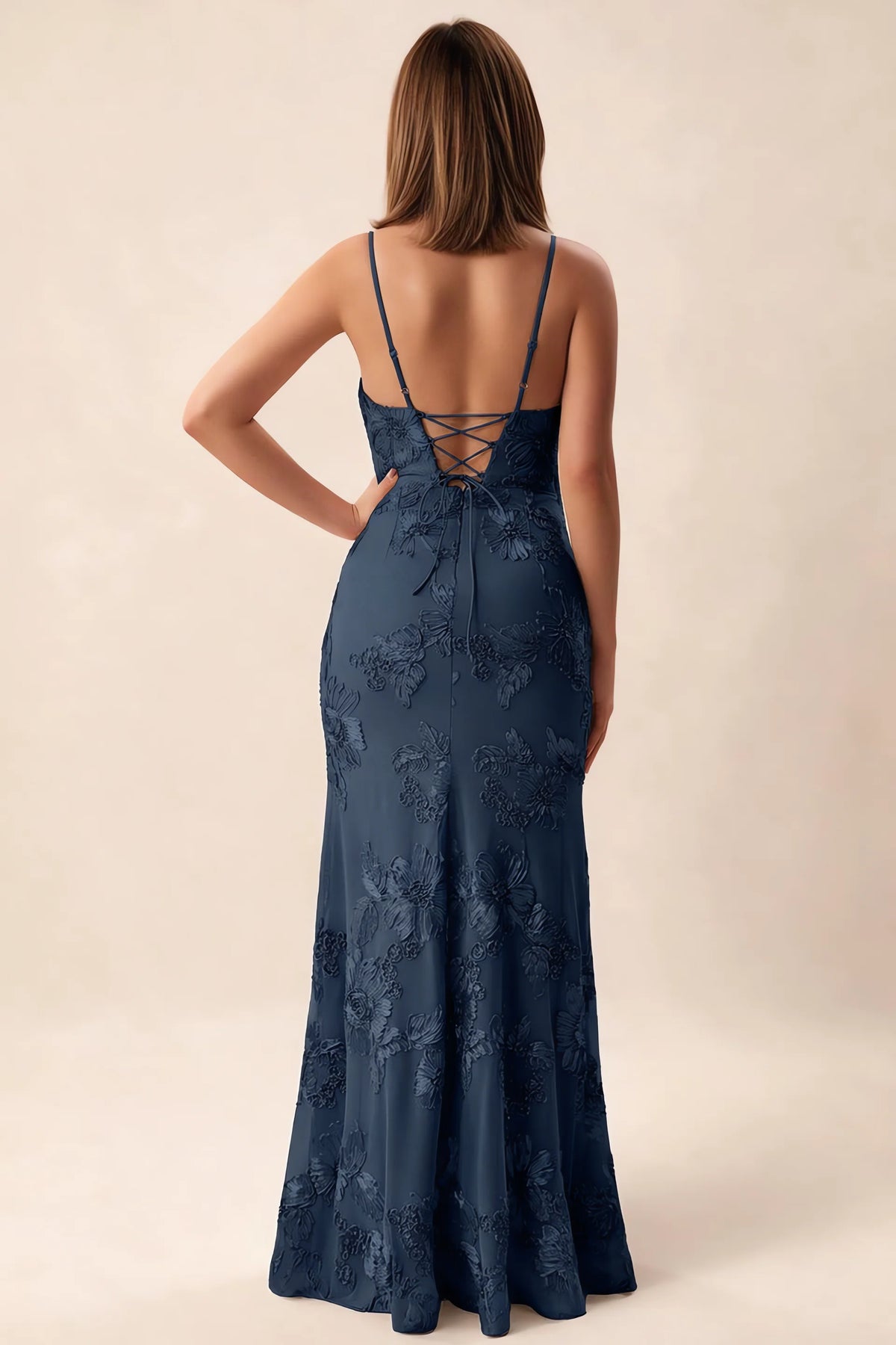 Rear studio view of Brianna navy dress showing adjustable shoulder straps and crossed back lacing