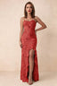 Front studio view of Brianna red floral maxi dress with thin straps and a high ruffle-edged opening