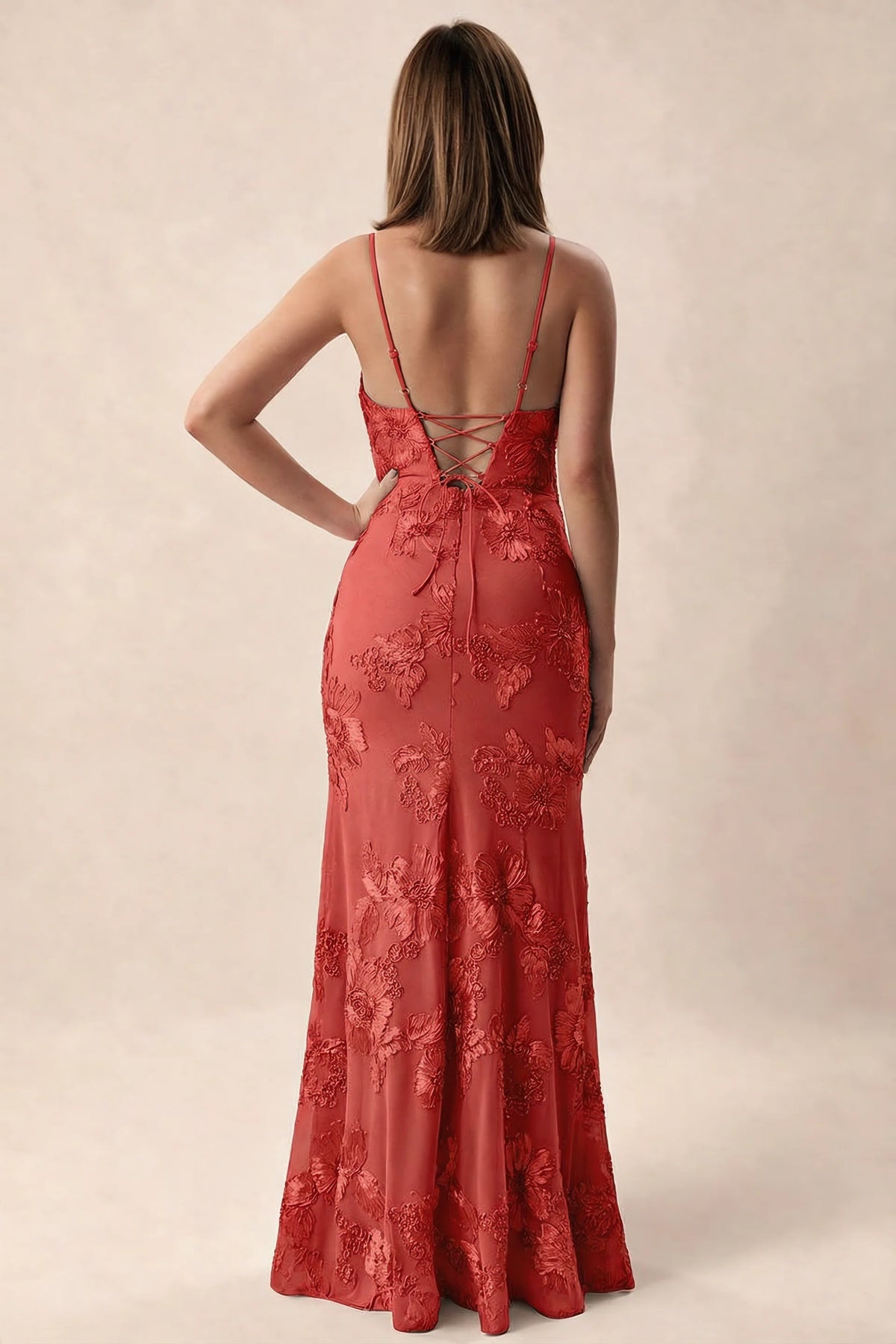 Rear studio view of Brianna red dress showing adjustable shoulder straps and crossed back lacing