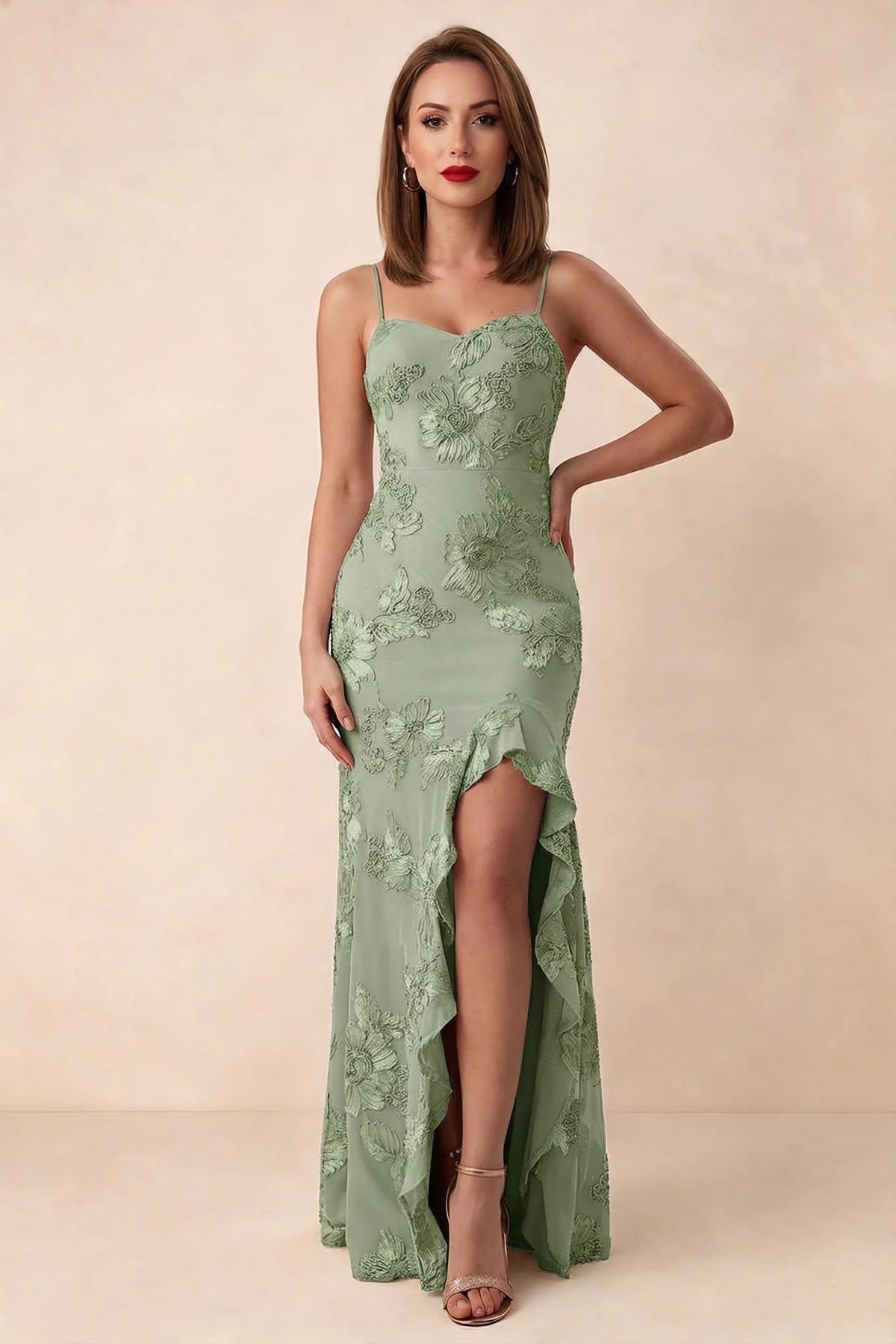 Front studio view of Brianna sage green floral maxi dress with thin straps and a high ruffle-edged opening