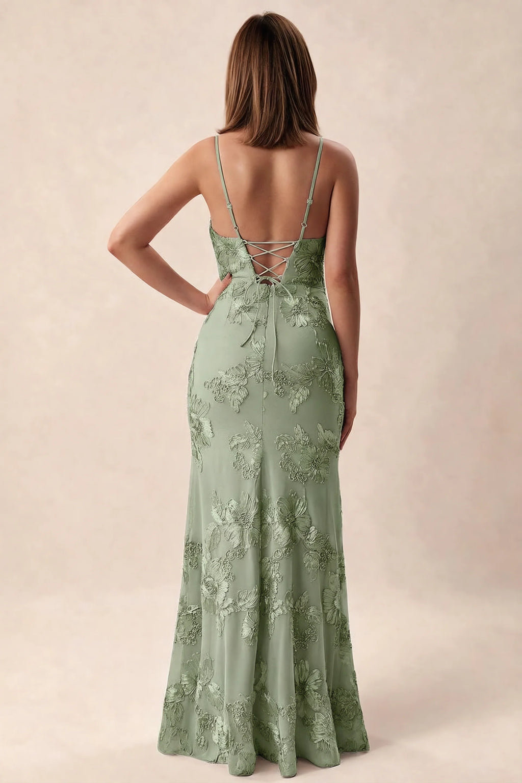 Rear studio view of Brianna sage green dress showing adjustable shoulder straps and crossed back lacing