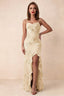 Front studio view of Brianna yellow floral maxi dress with thin straps and a high ruffle-edged opening