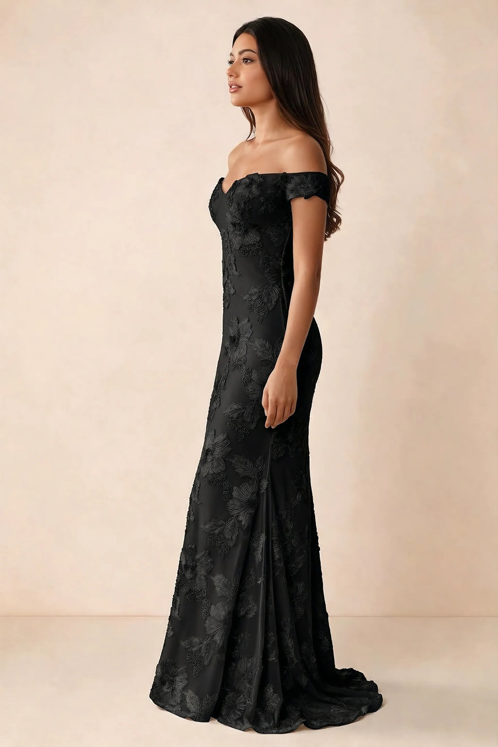Side studio view of Bridgette black dress showing the fitted hips and trailing back hem