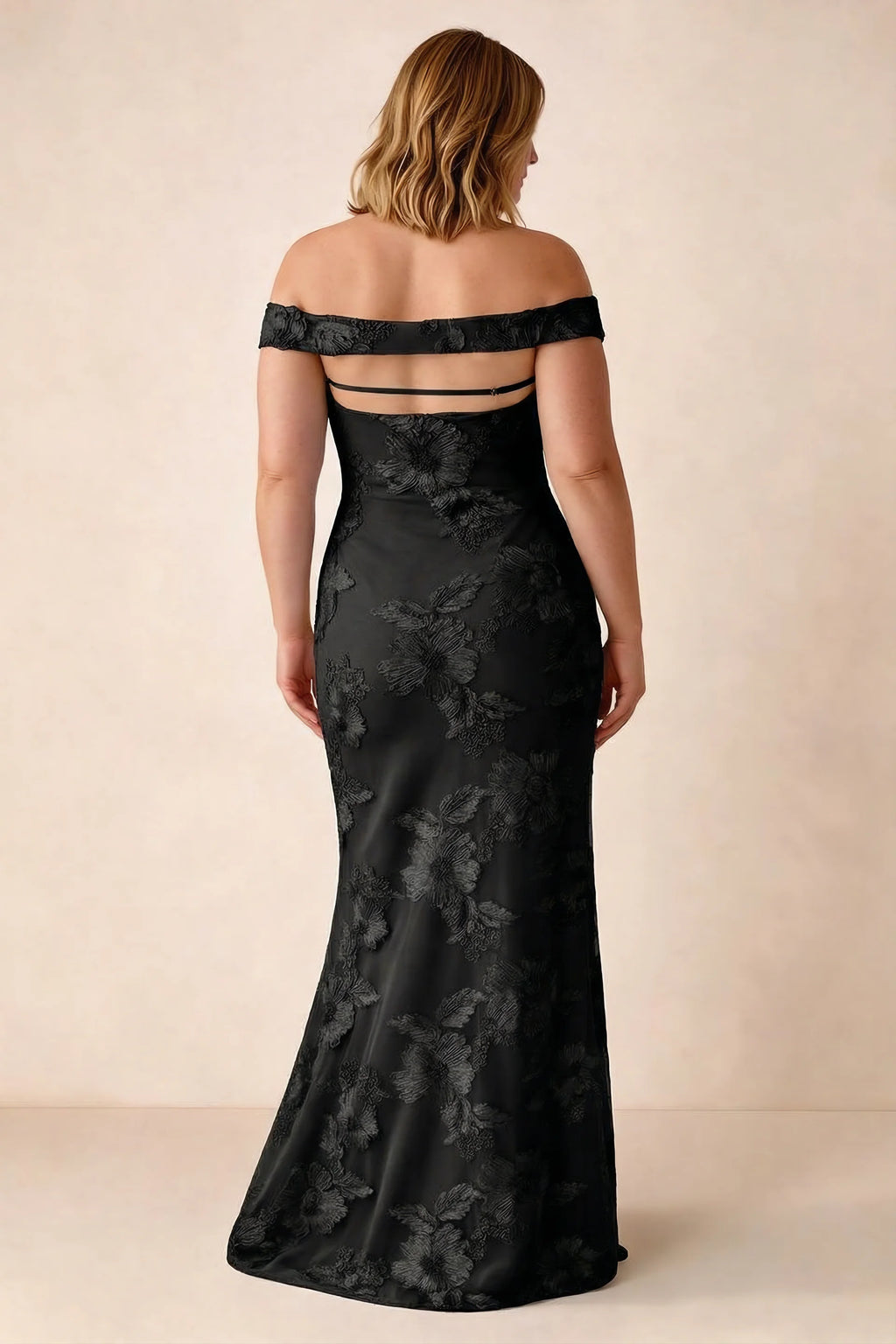 Rear studio view of Bridgette black dress on a second model, showing the flared skirt