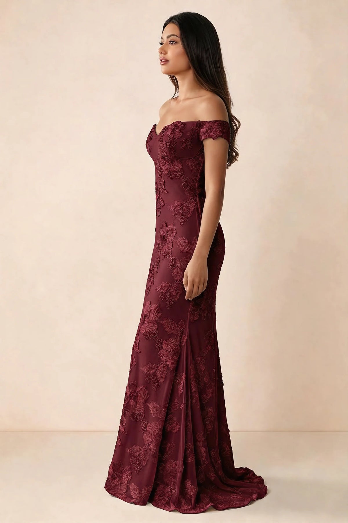 Side studio view of Bridgette burgundy dress showing the fitted hips and trailing back hem