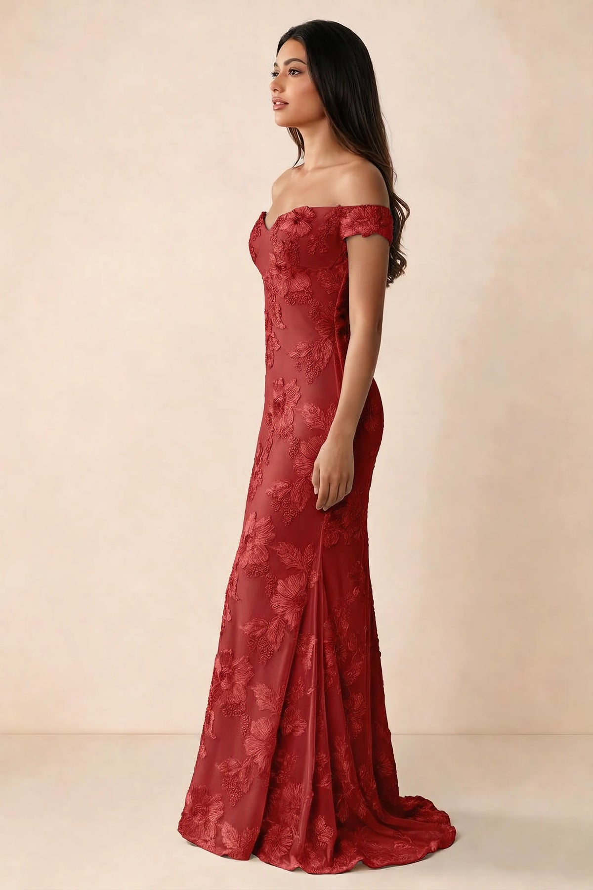 Side studio view of Bridgette red dress showing the fitted hips and trailing back hem