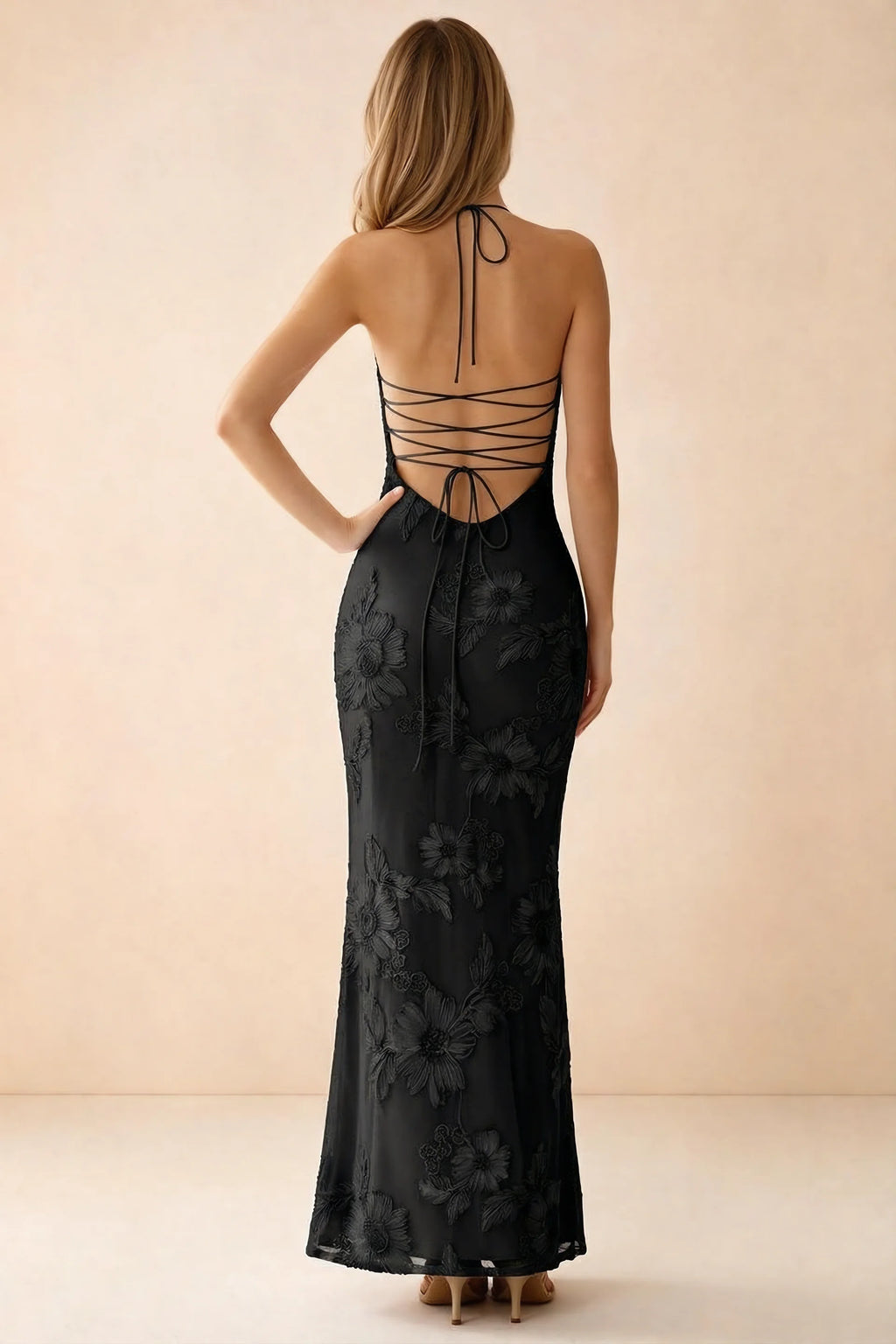 Rear studio view of Brigitte black dress showing crossed lacing across the low open back