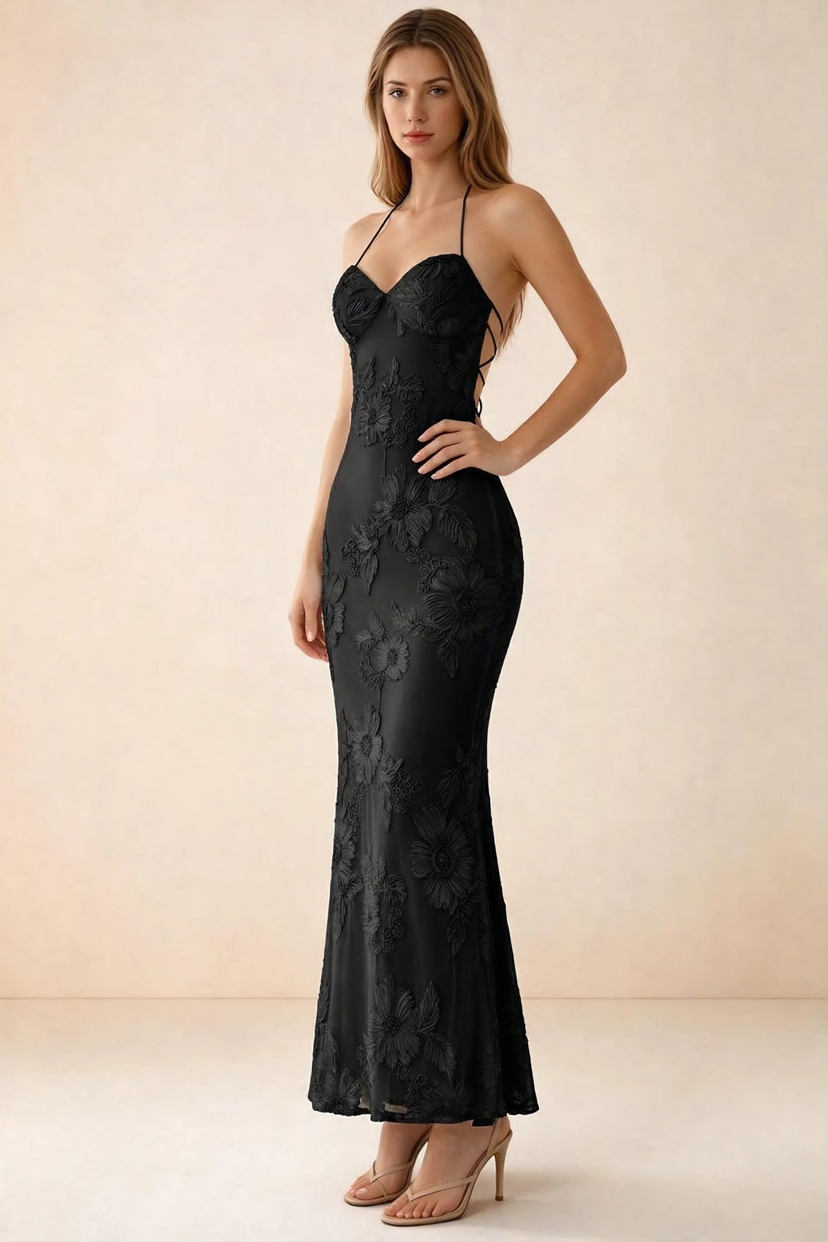 Three-quarter studio view of Brigitte black dress showing the fitted hips and ankle-skimming hem
