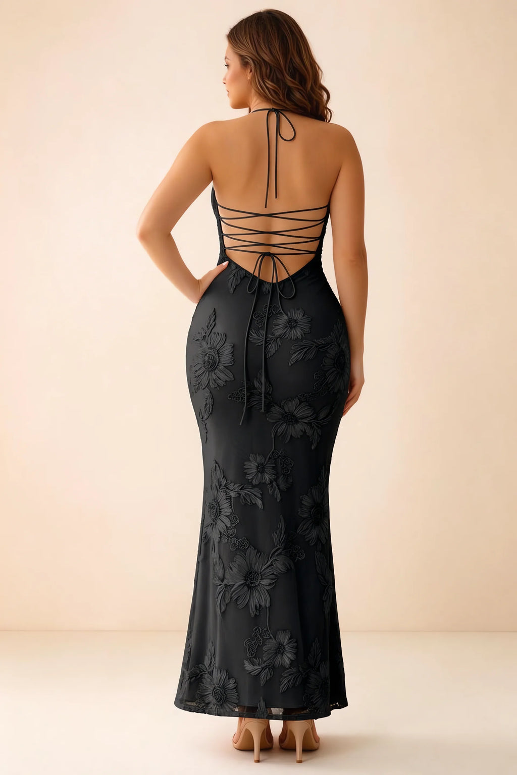 Rear studio view of Brigitte black dress on a second model, showing the back lacing and long skirt