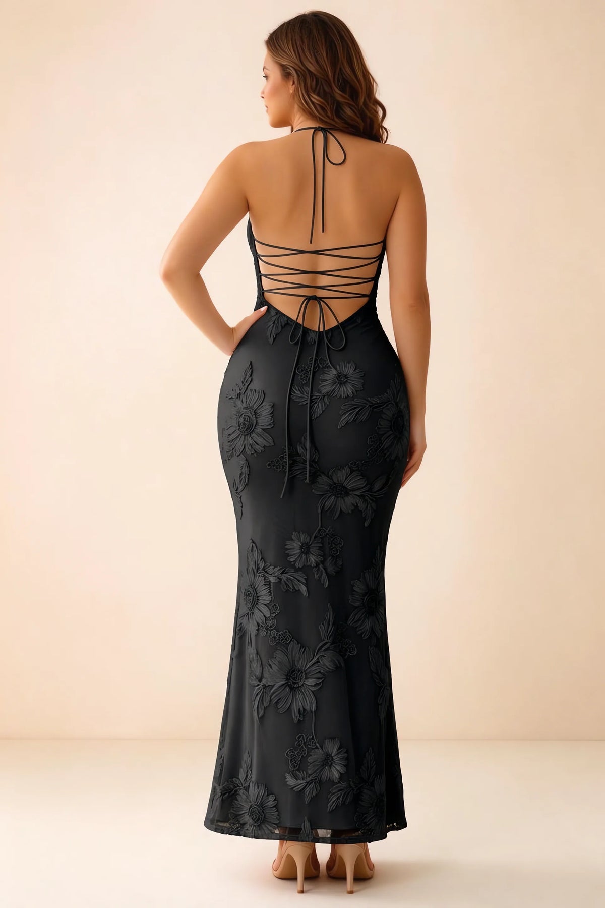 Rear studio view of Brigitte black dress on a second model, showing the back lacing and long skirt