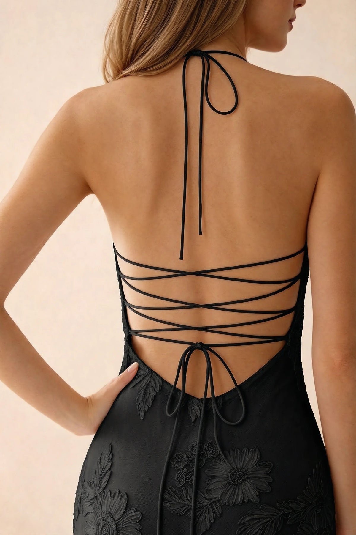 Close-up of Brigitte black neck tie and crossed lacing across the open back
