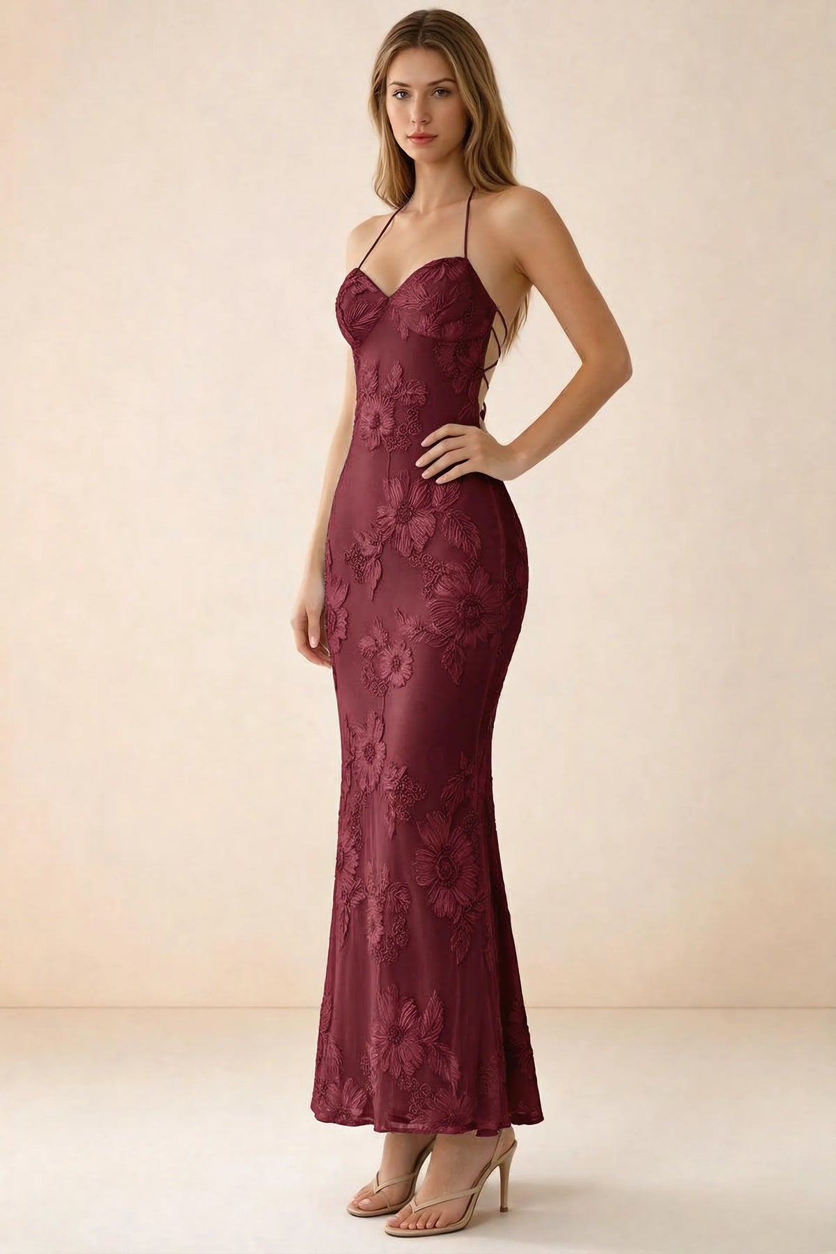 Three-quarter studio view of Brigitte burgundy dress showing the fitted hips and ankle-skimming hem