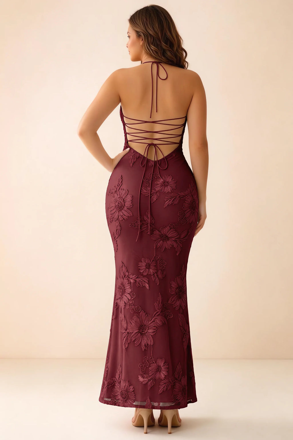 Rear studio view of Brigitte burgundy dress on a second model, showing the back lacing and long skirt