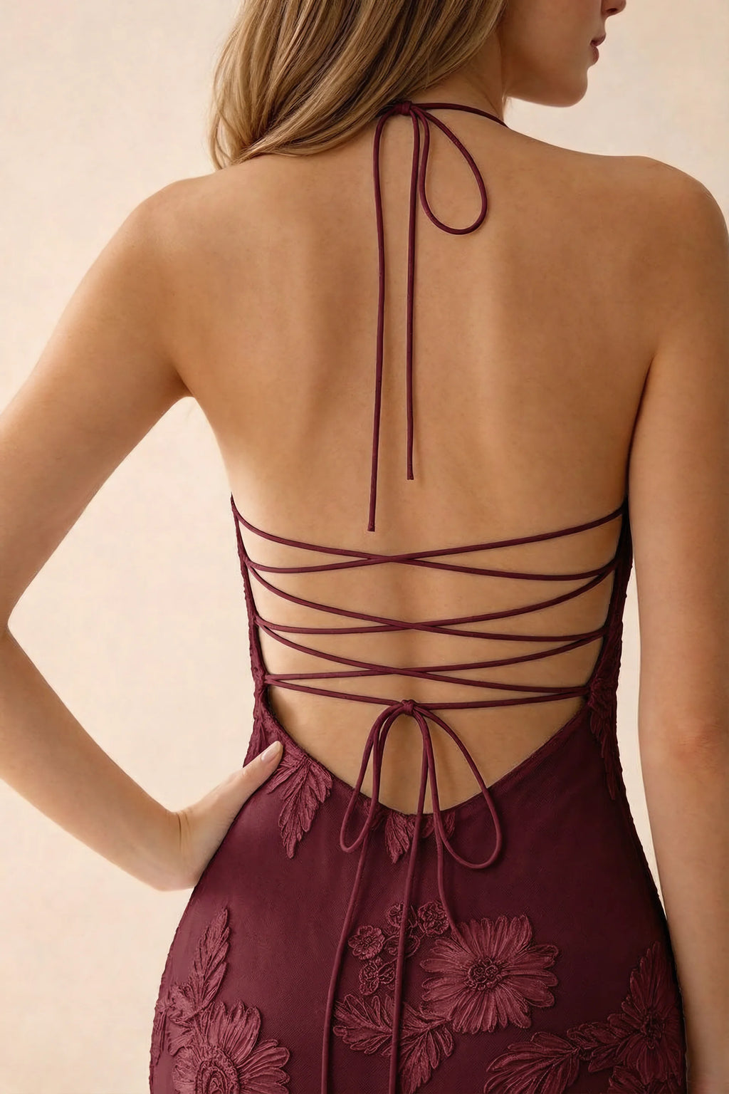Close-up of Brigitte burgundy neck tie and crossed lacing across the open back