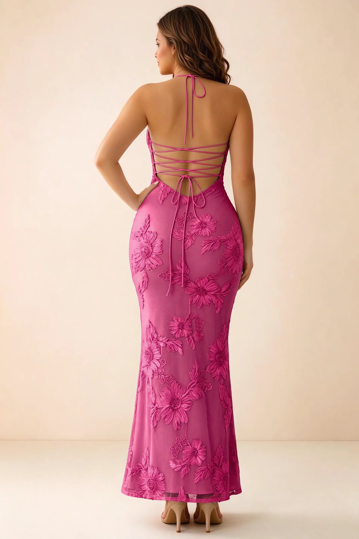 Rear studio view of Brigitte fuchsia dress on a second model, showing the back lacing and long skirt