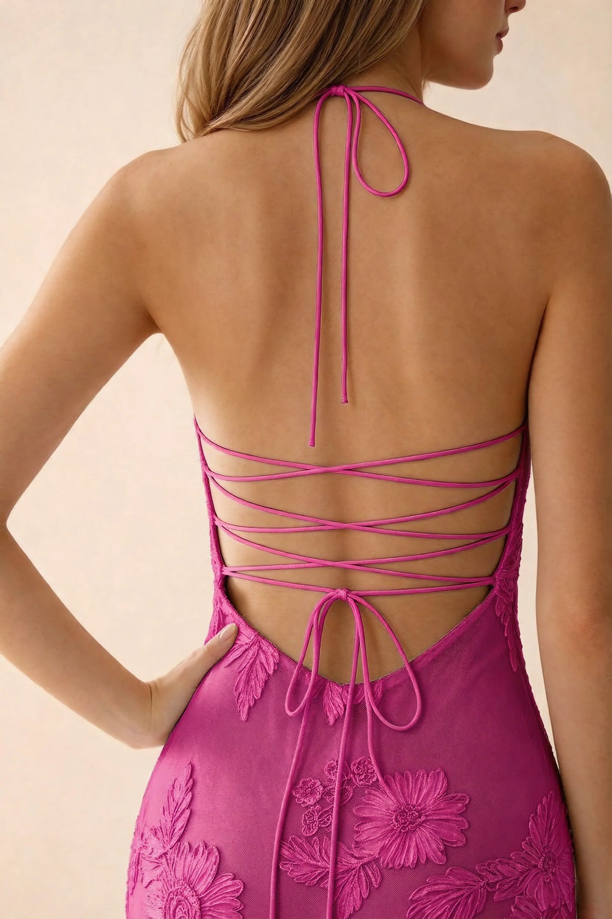 Close-up of Brigitte fuchsia neck tie and crossed lacing across the open back