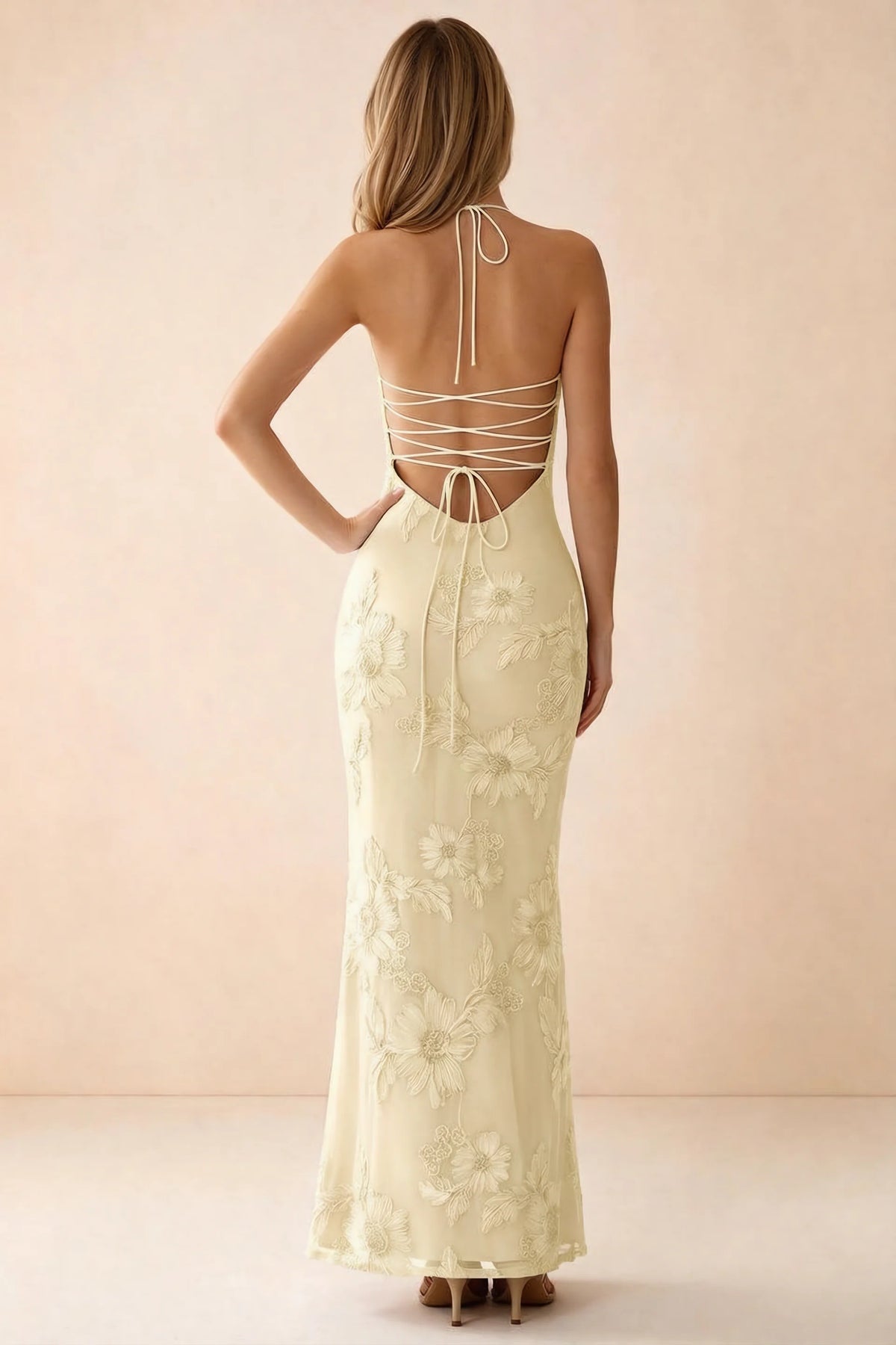Rear studio view of Brigitte lemon dress showing crossed lacing across the low open back