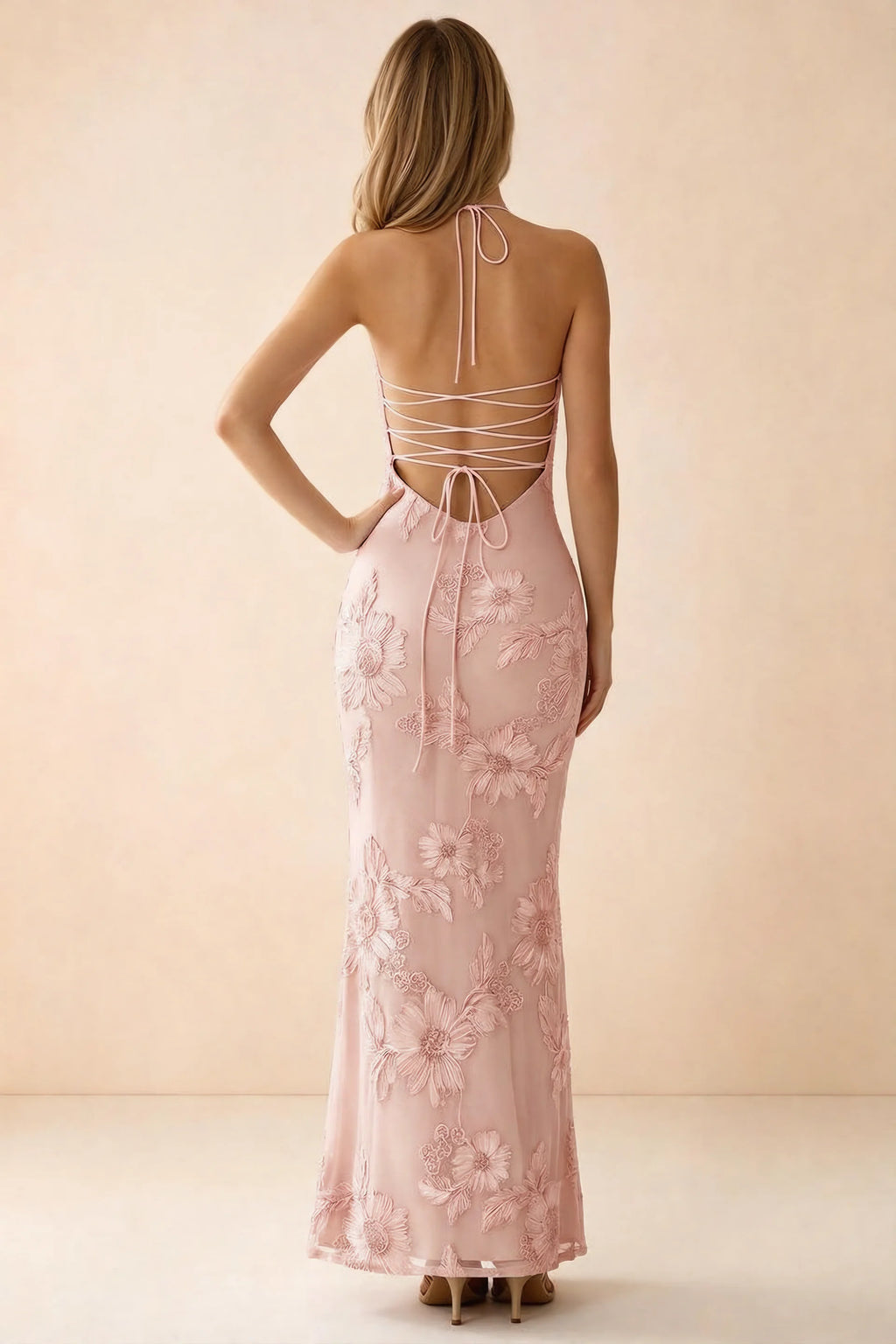 Rear studio view of Brigitte light pink dress showing crossed lacing across the low open back