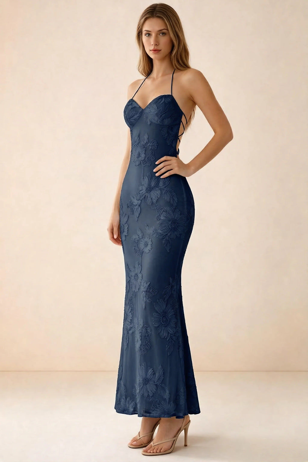 Three-quarter studio view of Brigitte navy dress showing the fitted hips and ankle-skimming hem