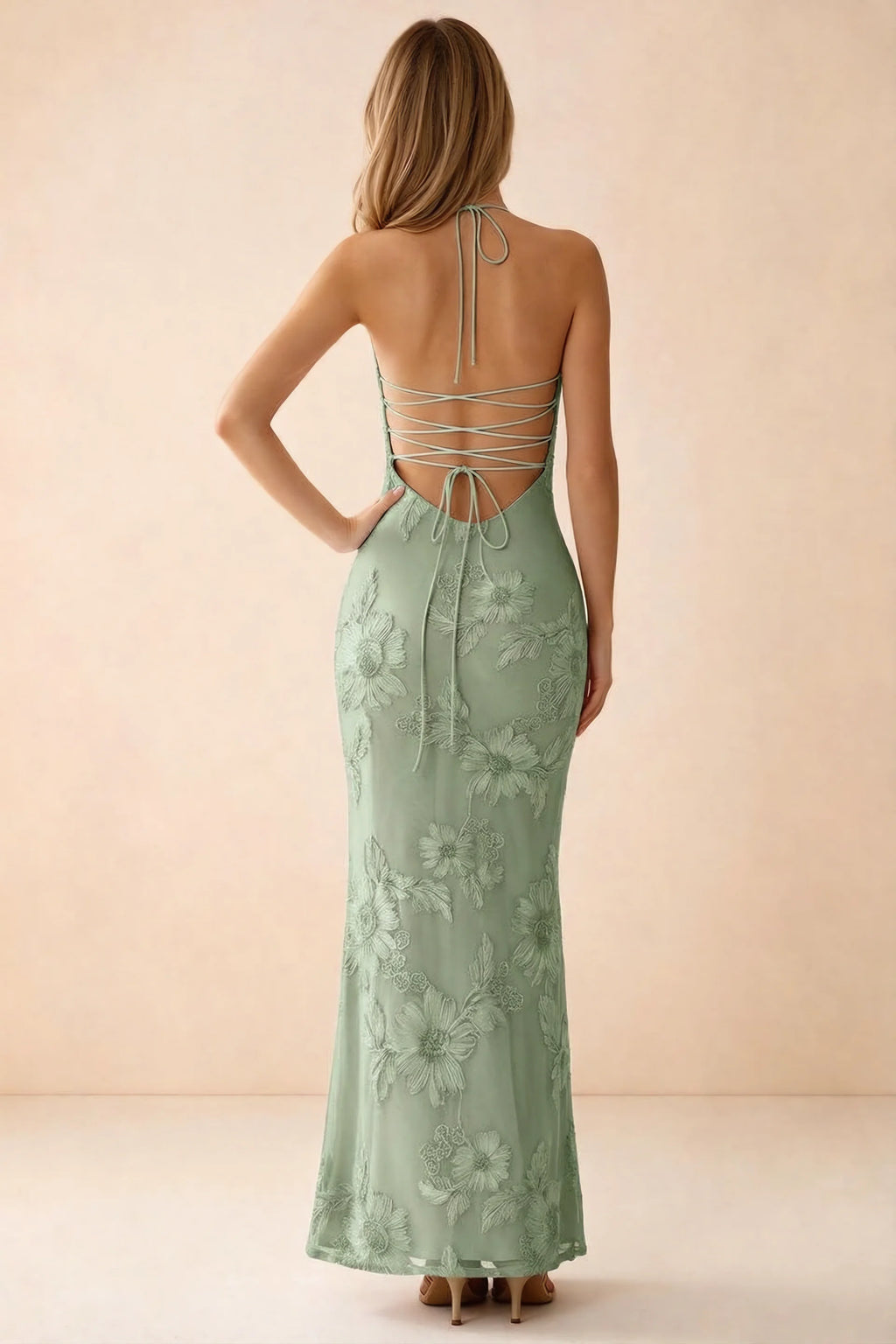 Rear studio view of Brigitte sage green dress showing crossed lacing across the low open back