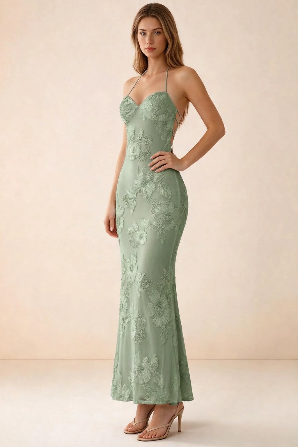Three-quarter studio view of Brigitte sage green dress showing the fitted hips and ankle-skimming hem