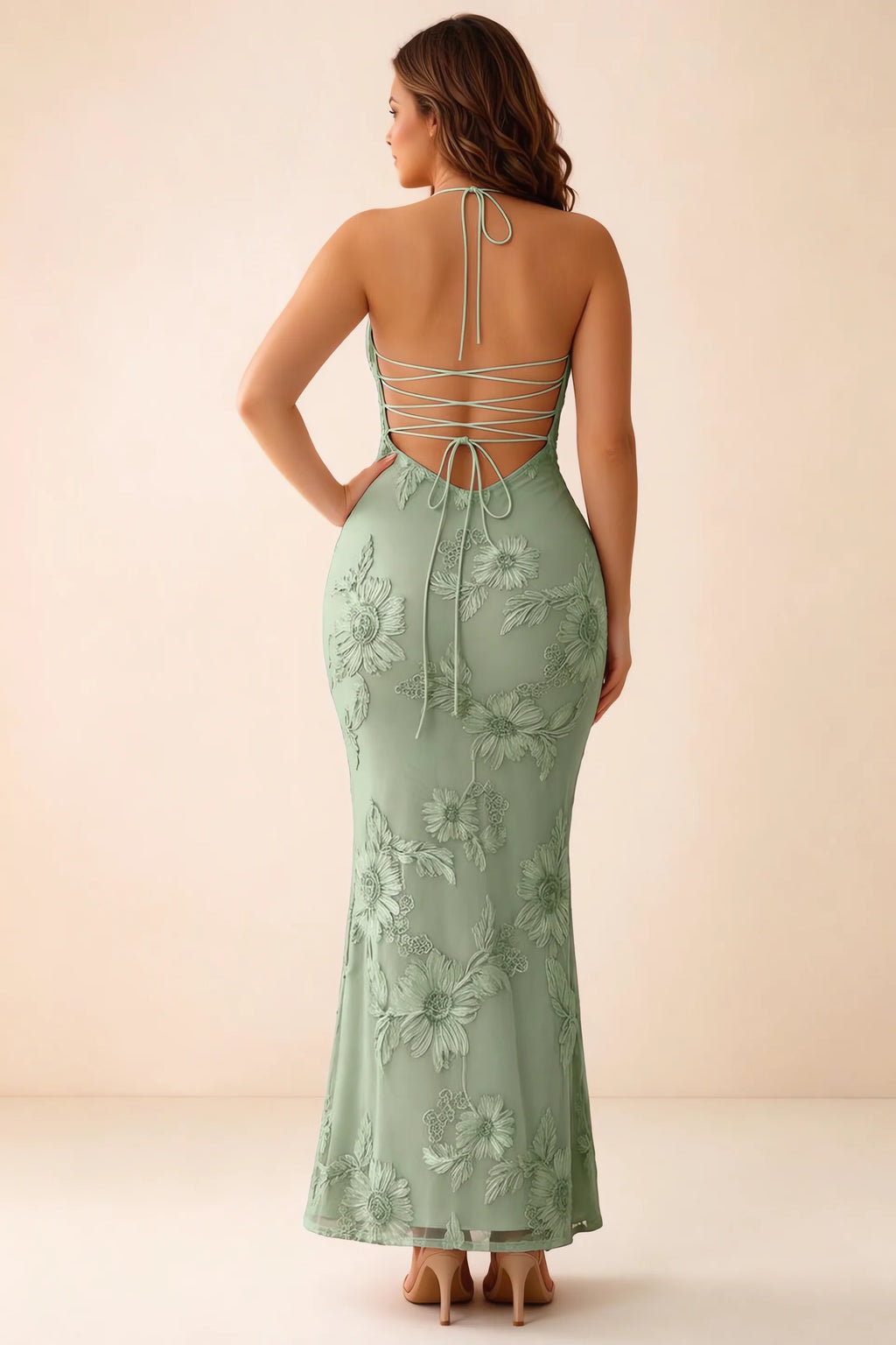 Rear studio view of Brigitte sage green dress on a second model, showing the back lacing and long skirt