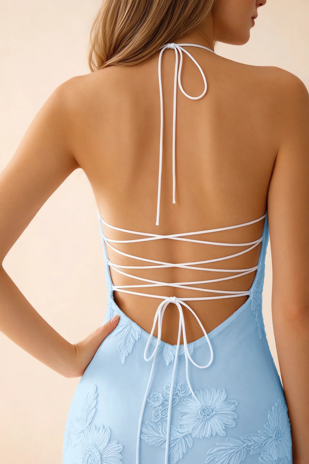 Close-up of Brigitte sky blue neck tie and crossed lacing across the open back