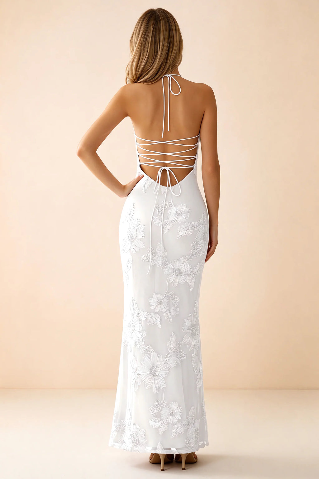 Rear studio view of Brigitte white dress showing crossed lacing across the low open back