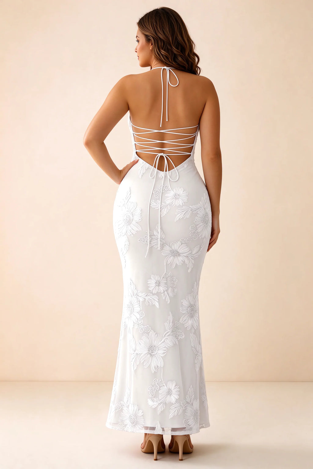 Rear studio view of Brigitte white dress on a second model, showing the back lacing and long skirt