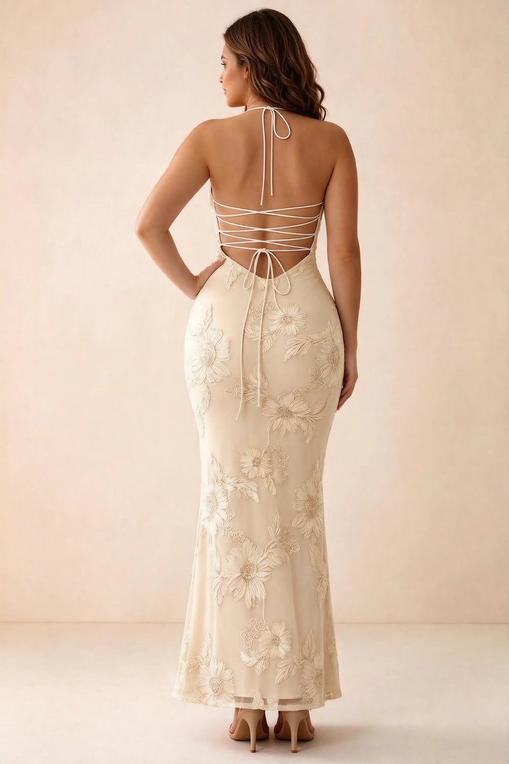 Rear studio view of Brigitte yellow dress on a second model, showing the back lacing and long skirt