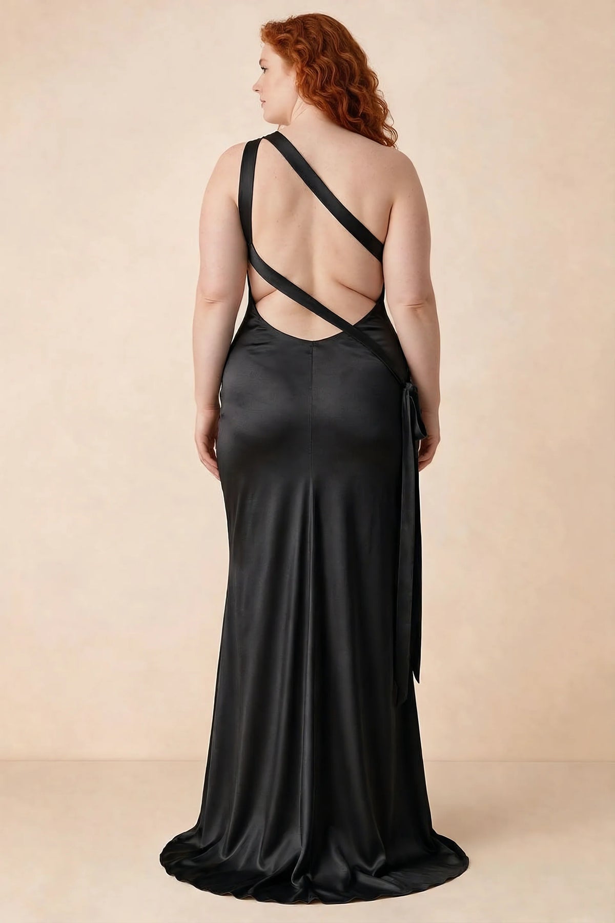 Rear studio view of Brittany black dress on a second model, showing the crossing straps and flared hem