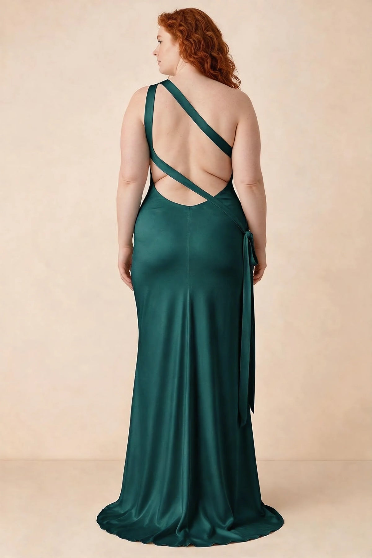 Rear studio view of Brittany peacock dress on a second model, showing the crossing straps and flared hem