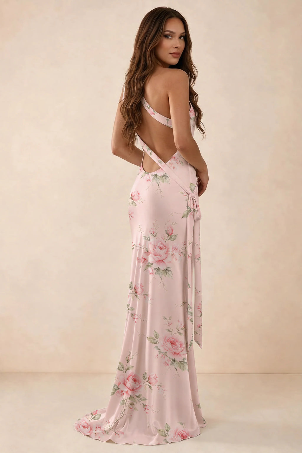 Rear three-quarter studio view of Brittany pink floral dress showing the crossed open back and long tie tails
