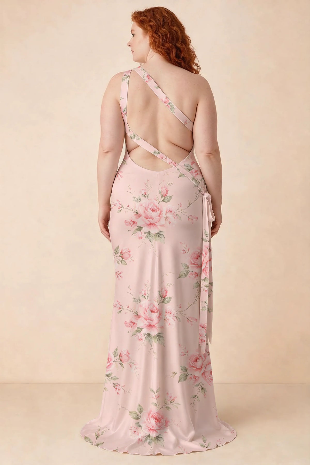Rear studio view of Brittany pink floral dress on a second model, showing the crossing straps and flared hem