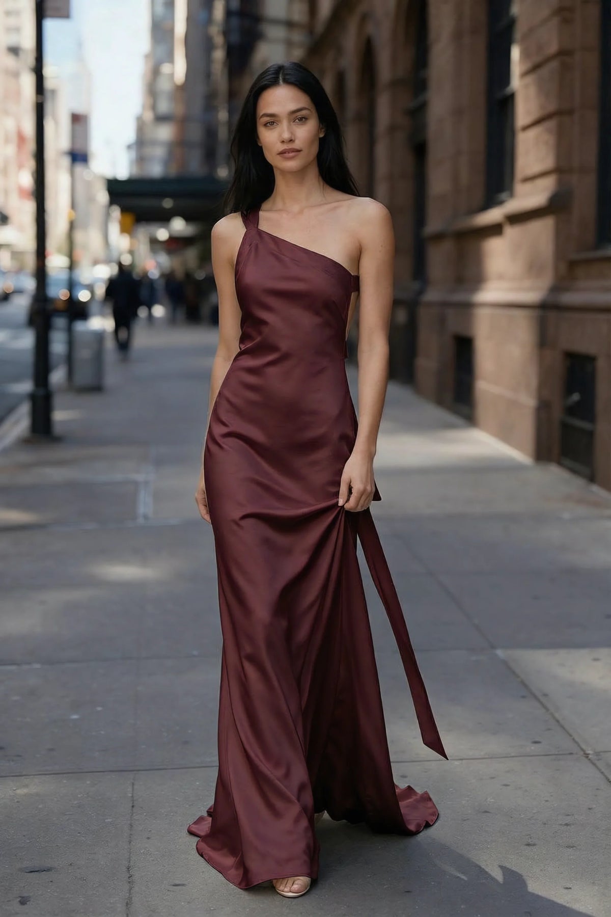 Outdoor front view of Brittany wine asymmetric dress on a city street