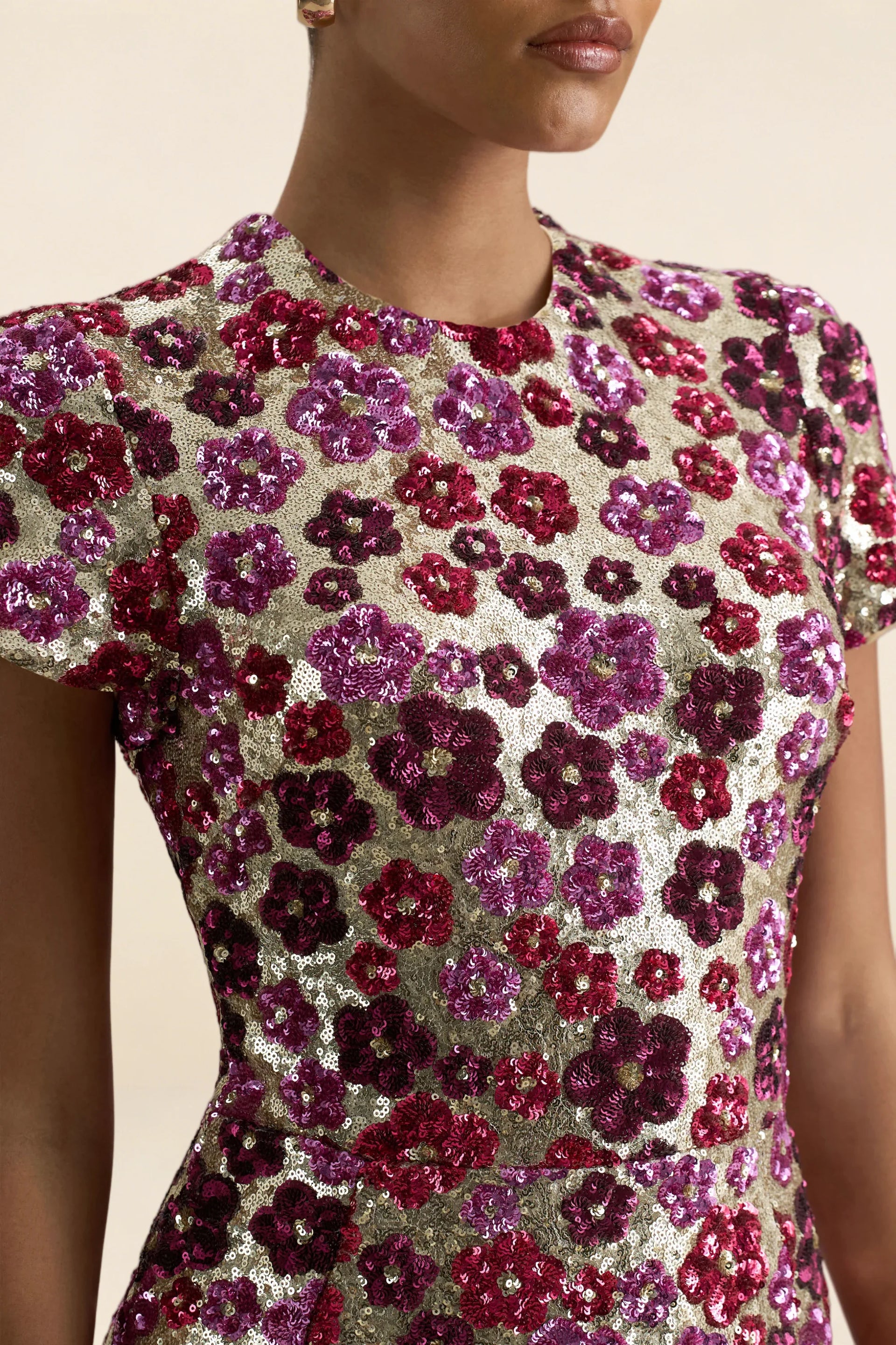 Close up detail of LVLVS Brooke pink floral sequin embroidery high neckline and short cap sleeves, showcasing craftsmanship for party wear