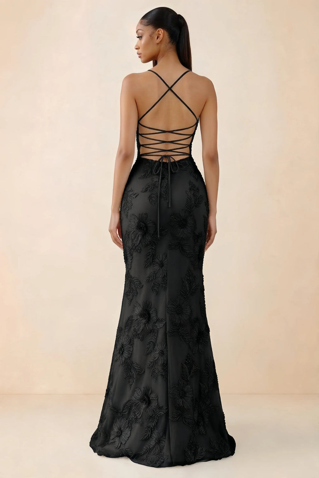 Rear studio view of Brynn black dress showing crossed shoulder straps and an open lace-up back