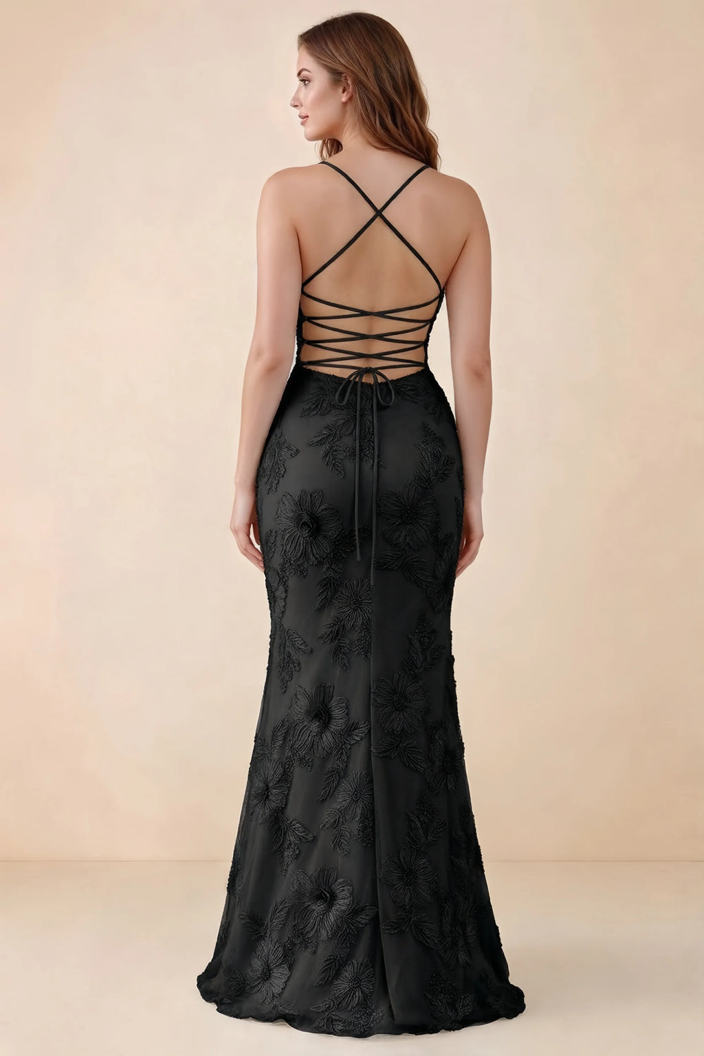 Rear studio view of Brynn black dress on a second model, showing the back lacing and floral skirt