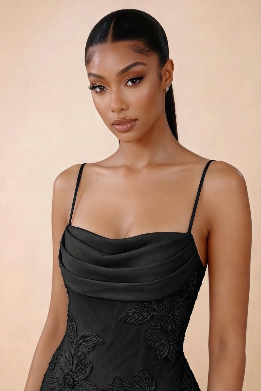Close-up of Brynn black draped cowl neckline, thin shoulder straps and floral bodice