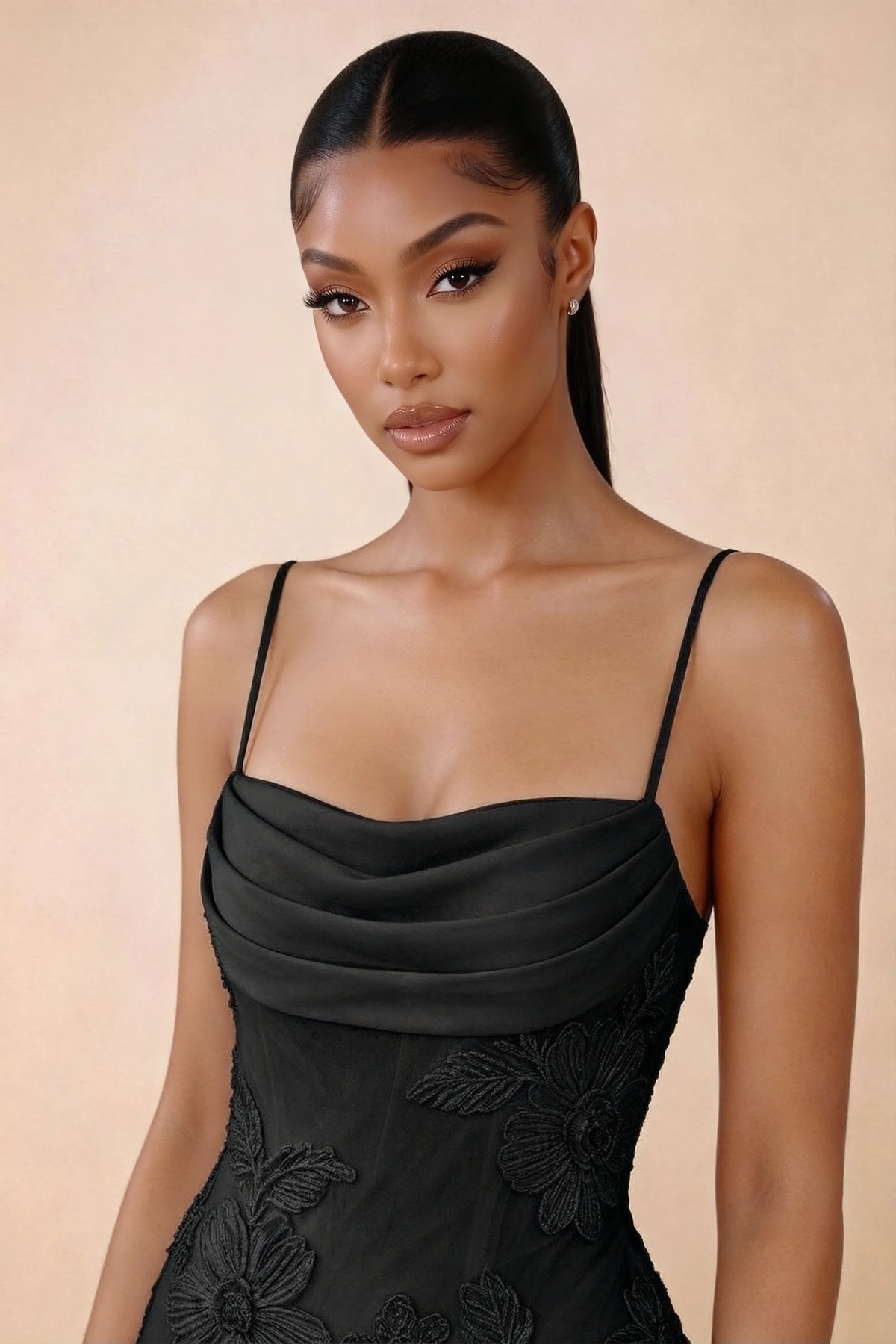 Close-up of Brynn black draped cowl neckline, thin shoulder straps and floral bodice