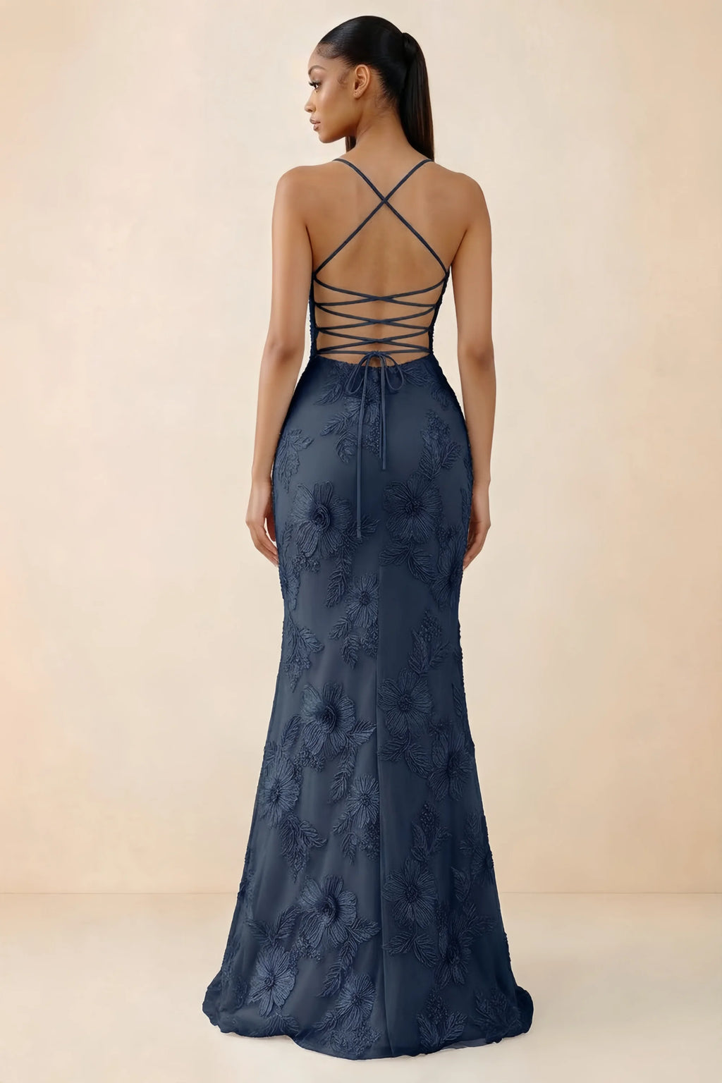 Rear studio view of Brynn navy dress showing crossed shoulder straps and an open lace-up back
