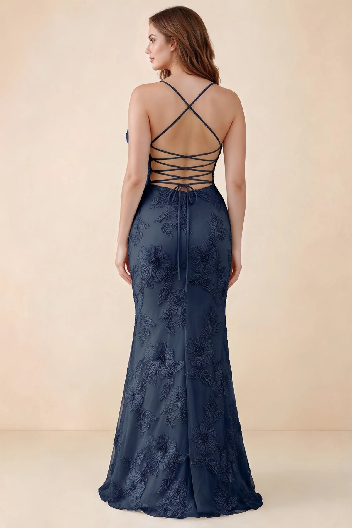 Rear studio view of Brynn navy dress on a second model, showing the back lacing and floral skirt
