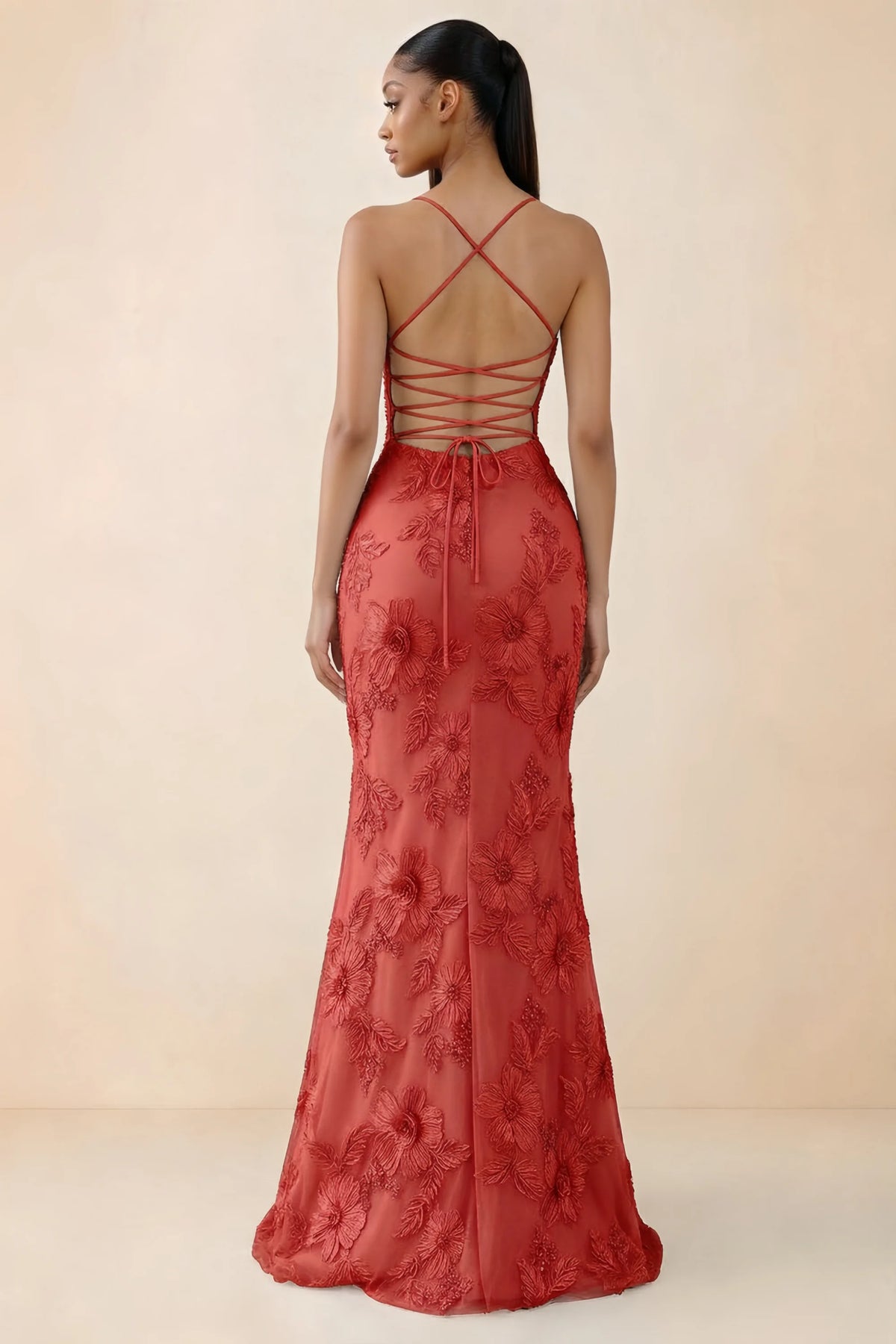 Rear studio view of Brynn red dress showing crossed shoulder straps and an open lace-up back