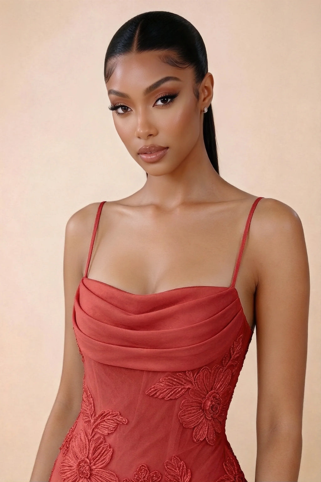 Close-up of Brynn red draped cowl neckline, thin shoulder straps and floral bodice