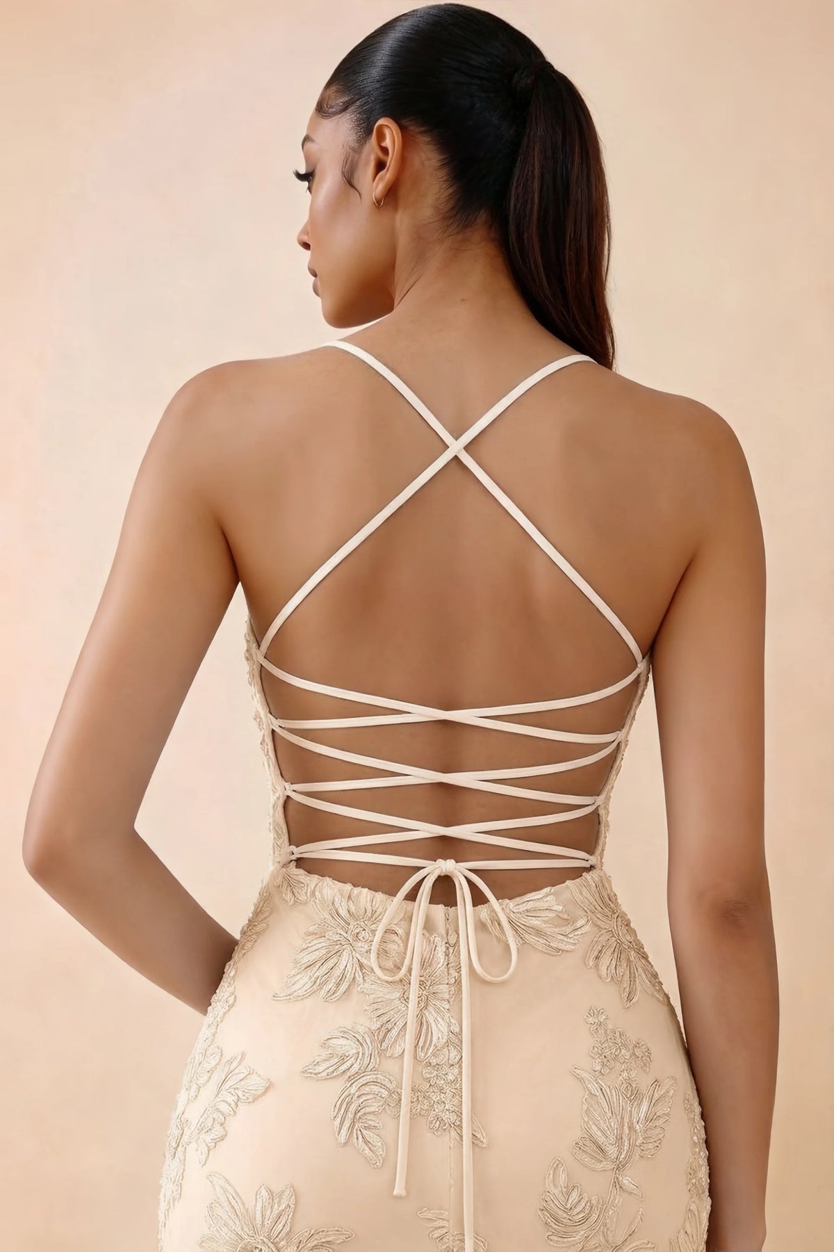 Close-up of Brynn yellow crossed shoulder straps and lacing through the open back