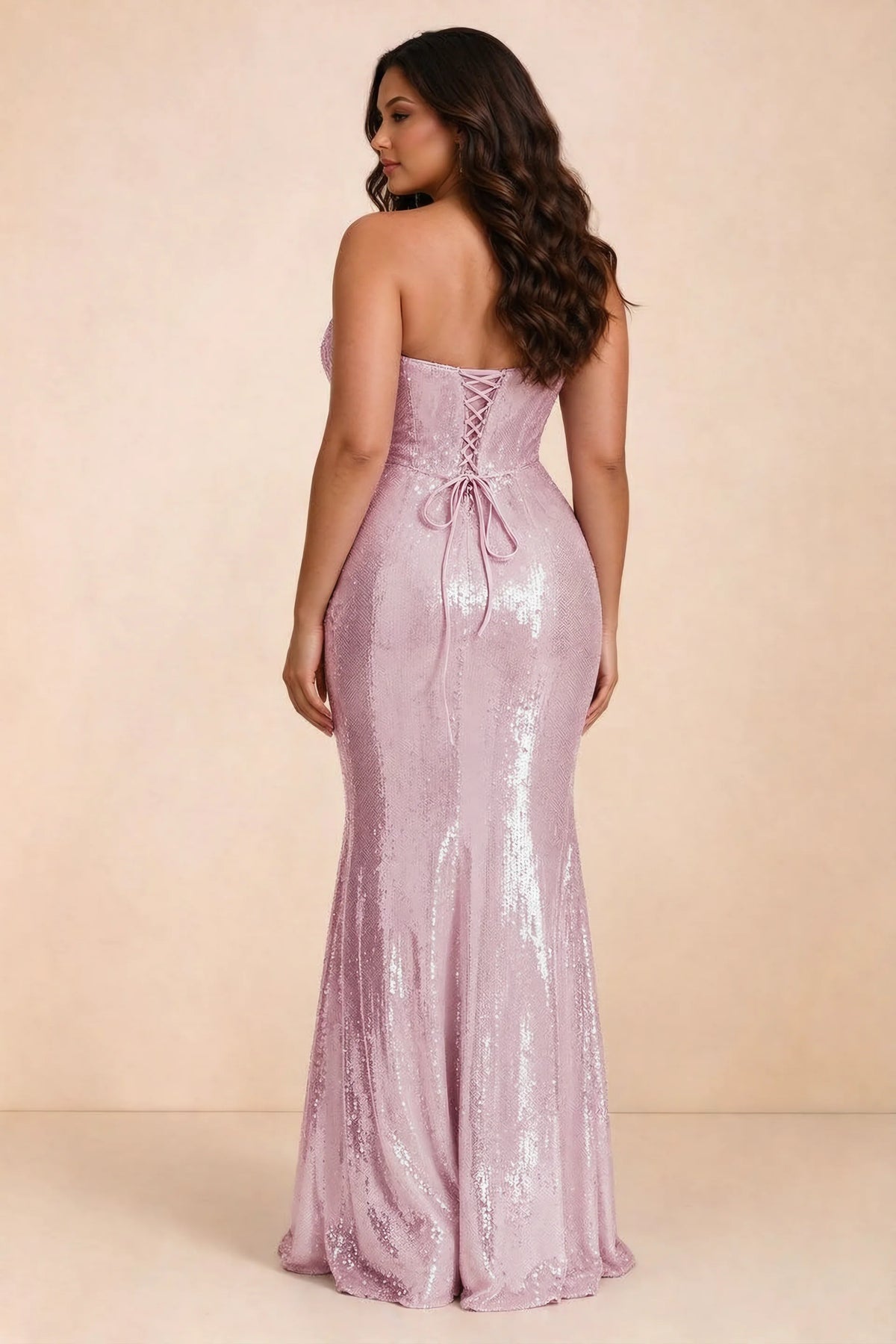 Rear studio view of Calista dusty pink dress on a second model, showing the back lacing and sequin skirt